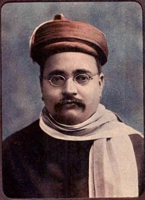 Gopal Krishna Gokhale in a round cap, spectacles and a shawl